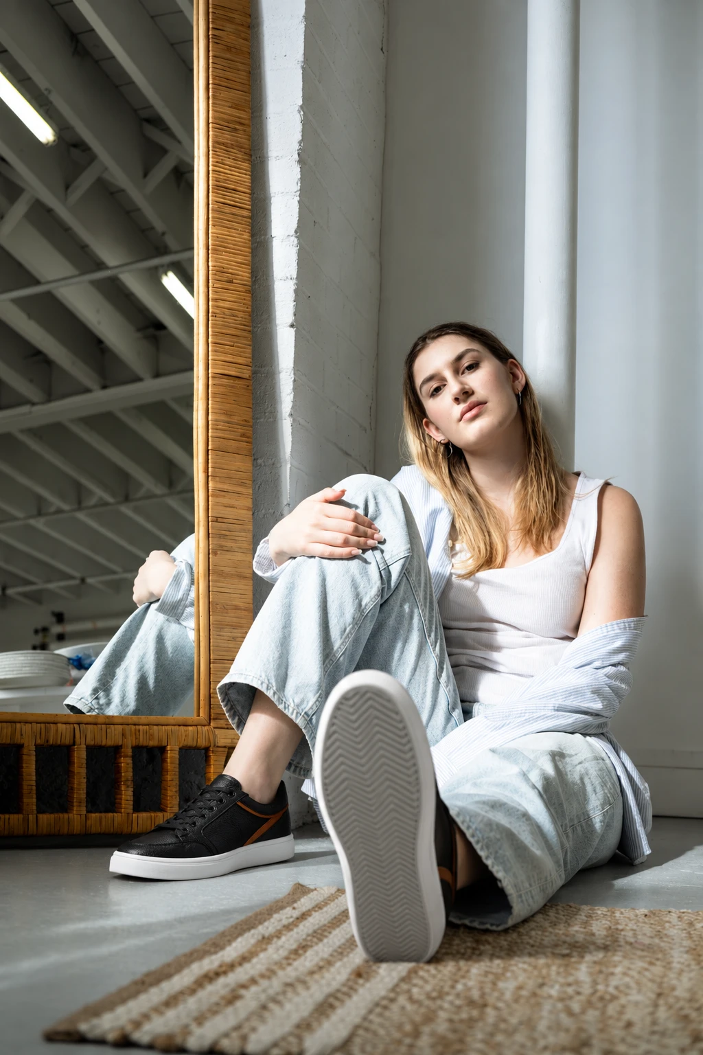 Wearing SELVA black leather sneakers by a mirror